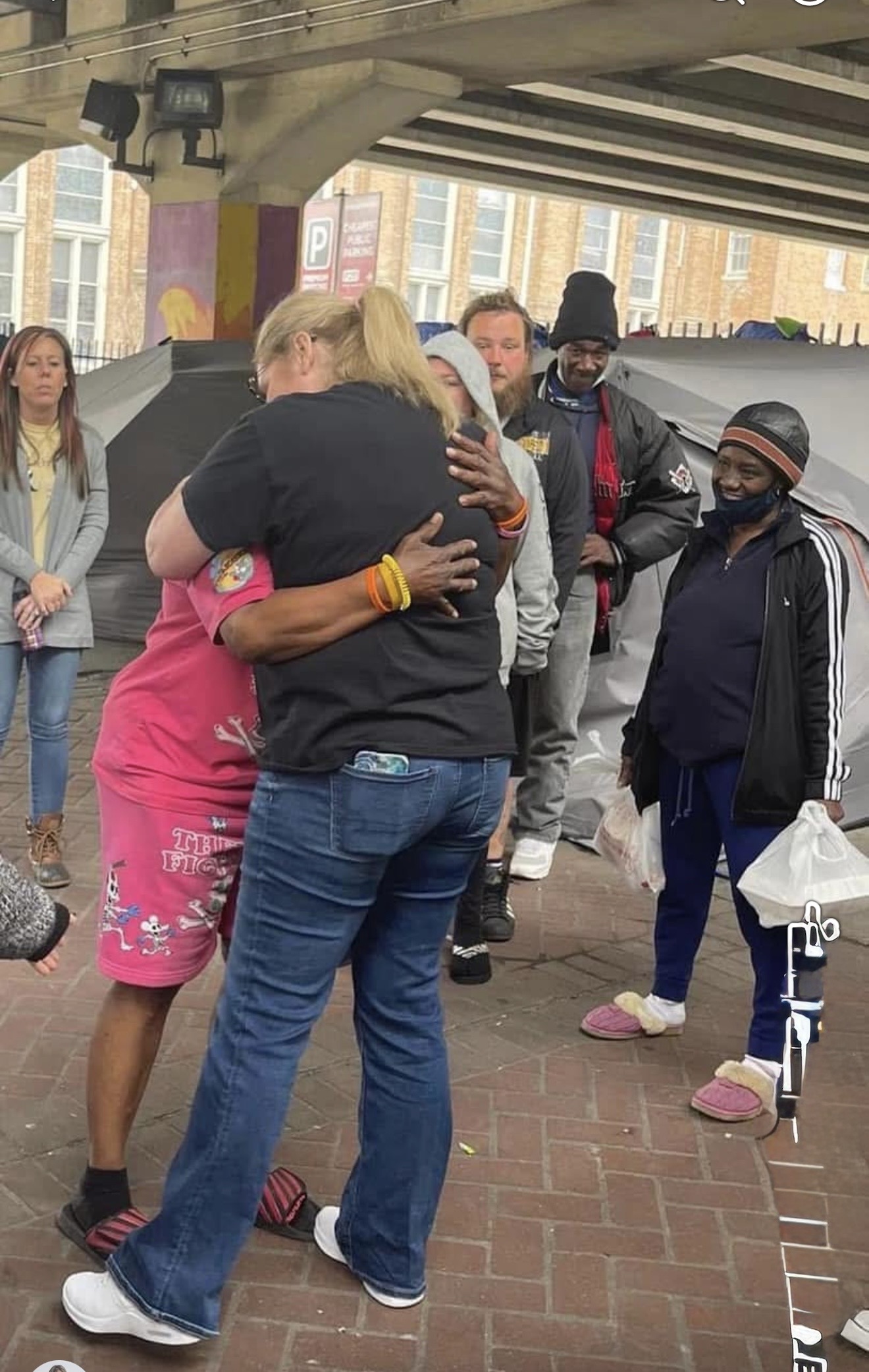 A Hearts for NOLA team member embracing a woman in the French Quarter