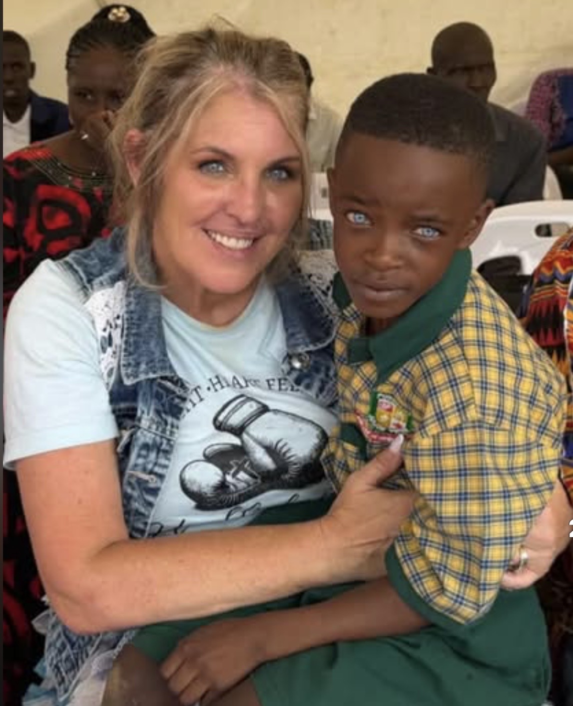 Angela Stress embracing a Pursuant Junior School student